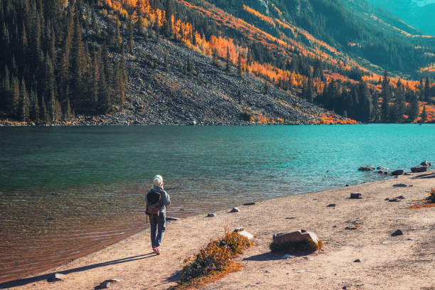 Young woman hiking in Aspen, Colorado Woman hiking in Maroon Bells Snowmass Wilderness Area aspen colorado stock pictures, royalty-free photos & images