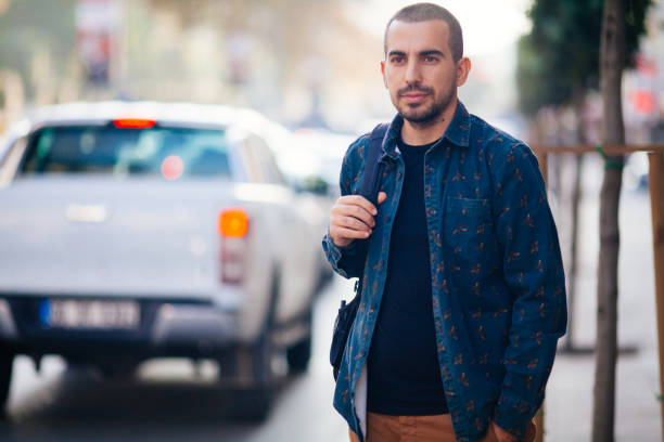 istock Young man waiting for taxi 868109360