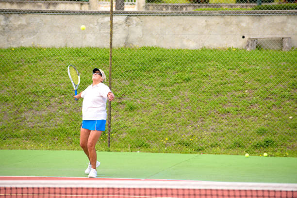 istock Senior tennis player serving 868109628