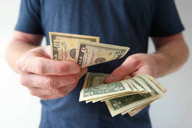 istock Man counting US dollar bills cash on hand 868109882