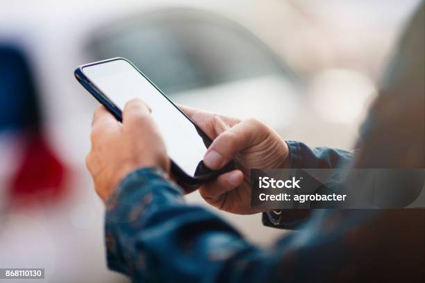 Man Using Smart Phone On Street Stock Photo - Download Image Now - Mobile Phone, Telephone, Men