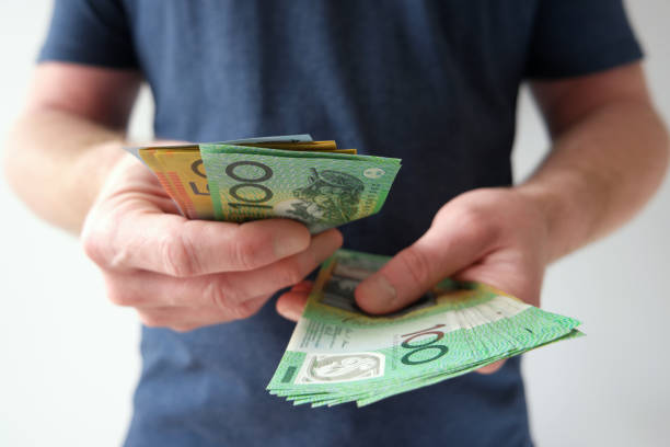 istock Man handling hundreds and fifties Australian dollar bills 868112230