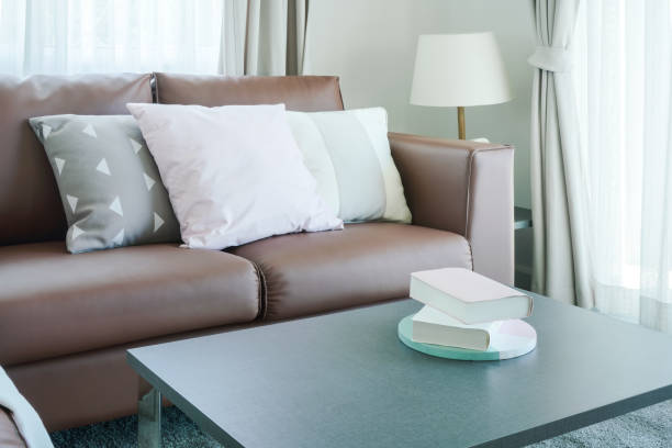 istock Books on center table with brown sofa in background 868112474