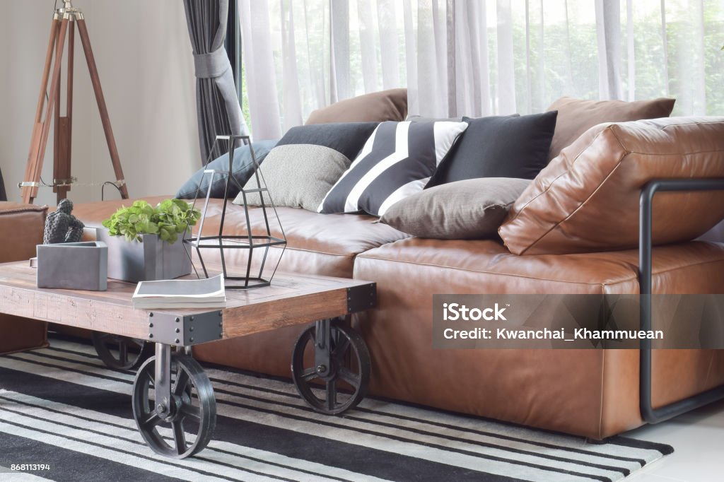 Wood Center Table With Wheel And Light Brown Leather Sofa In Industrial  Style Decoration Stock Photo - Download Image Now - iStock
