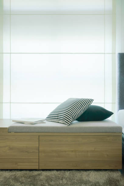 istock Pillows and books on cushion next to window in modern style interior bedroom 868113270
