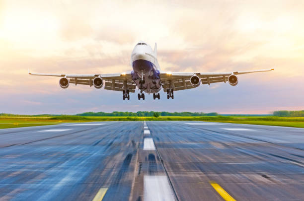 istock Passenger airplane landing at sunset on a runway. 868113280