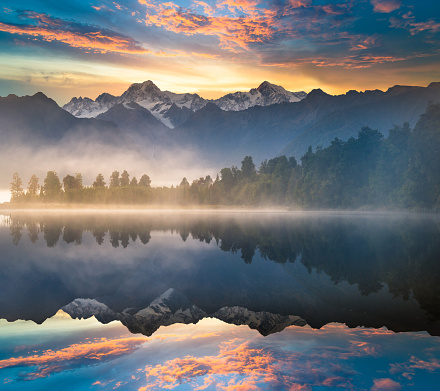 Incredible view of sunset over Fusine lake with Mangart peak on background. Popular travel destination of Julian Alps. Location: Tarvisio comune , Province of Udine, Italy, Europe