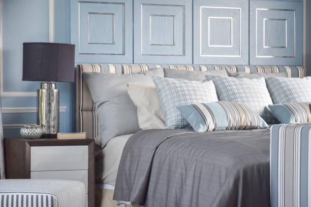 istock Striped an cross pattern pillows in light blue tone on classic gray bedding in classic light blue bedroom 868113742