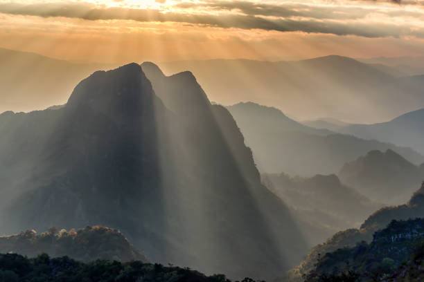 istock sunset over mountains.Beautiful sunlight ray on mountain with orange sky. 868114392