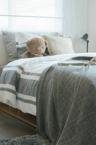 istock Brown teddy bear on bed in child's modern bedroom interior 868114482