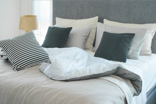 istock Messy bed with pillows in modern interior  bedroom 868117450