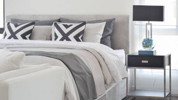 istock Modern Gray tone bedding and bedside table and lamp in black 868117520