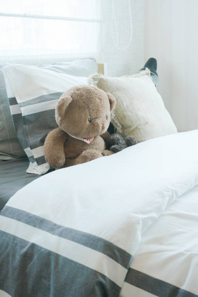 istock Brown bear and pillows on bed in child's bedroom 868121236