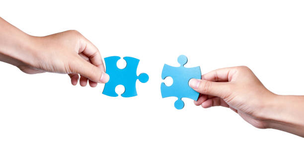 istock Two Puzzle Pieces Coming Together isolated on white background 868122544