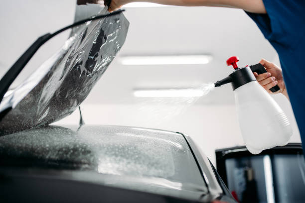 istock Male hand with spray, car window tint installation 868130052