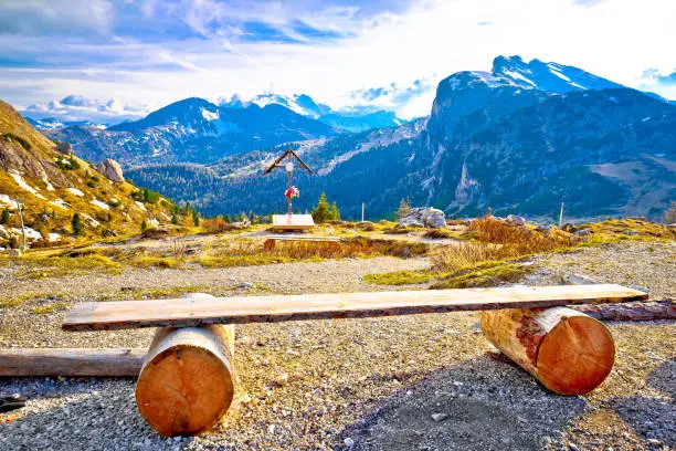 Bench and cross in Valparola Pass alpine destination, Dolomites Alps in South Tyrol region of Italy