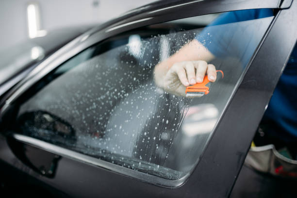 istock Specialist work with car, tinting film installing 868133022
