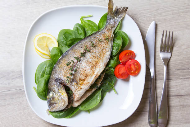 istock Baked dorado with spinach and pesto sauce. 868133556