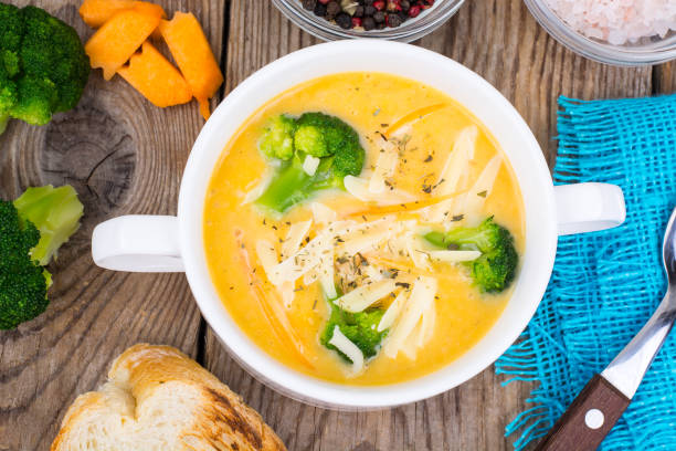 istock Vegetable cream soup with cheddar and broccoli on wooden table, rural dinner 868133684