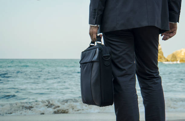 istock Waiting Businessman on the Beach 868143224