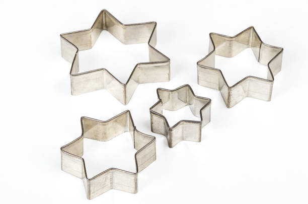 istock Four star shaped Christmas cookie cutters over white 868147412