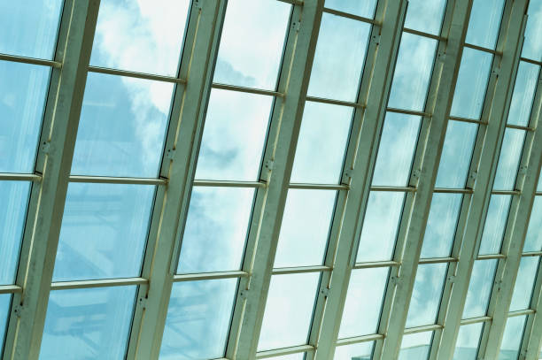 istock Modern glass office building with clouds and sky reflections 868153146
