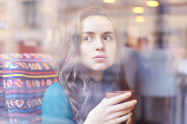 istock Beautiful lady enjoying cup of hot beverage, relaxing 868159280