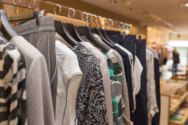 istock Different clothes on hangers close up in store 868159542