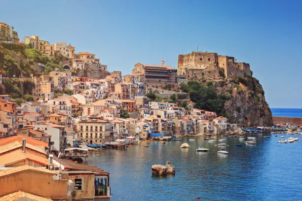 Scilla castle Ruffo, and harbor with fishing boats in Calabria, southern Italy.