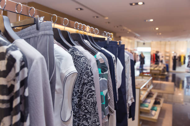 istock A row of clothes hanging on hangers in store 868159638