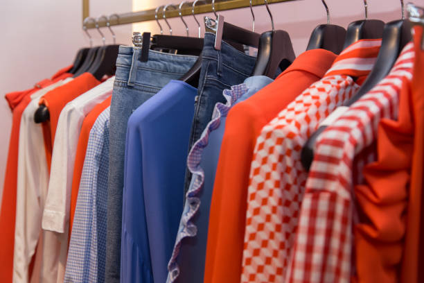 istock Different clothes on hangers close up in store 868159698