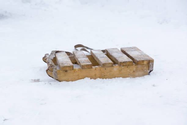 Red sledge on white snow.