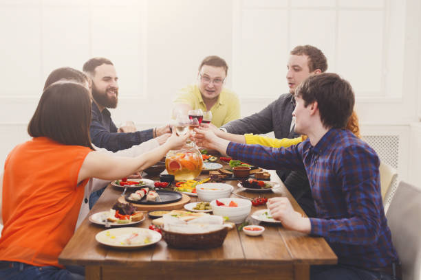 istock People say cheers clink glasses at festive table dinner party 868162634