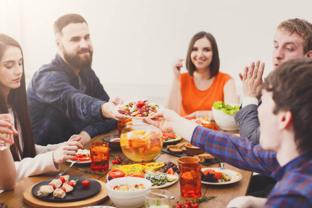 istock Group of happy people at festive table dinner party 868162988