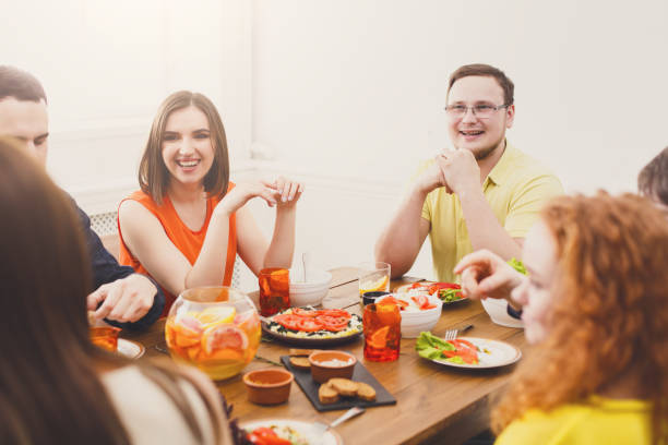 istock Group of happy people at festive table dinner party 868165244