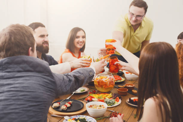 istock People say cheers clink glasses at festive table dinner party 868165452