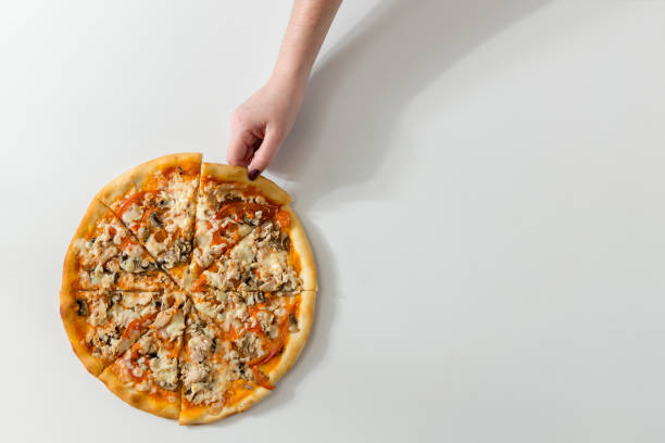 istock Female hand picking tasty slice, studio shot on white background with natural shadow 868166014