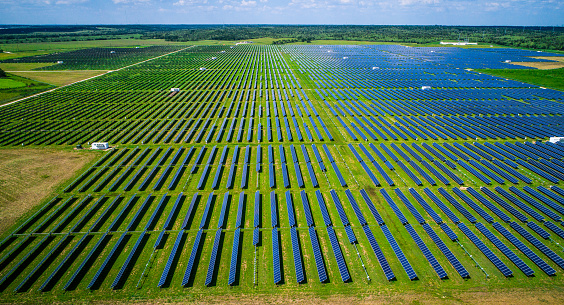 Side View Renewable Energy Power Plant from above Drone view overlooking thousands of Solar Panels power homes across Central Texas with clean sustainable and renewable energy that costs less than Fossil Fuel Energy technology.