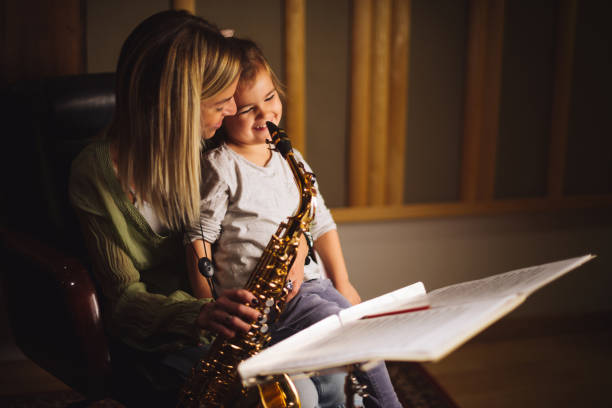 istock Cute girl playing saxophone 868169692