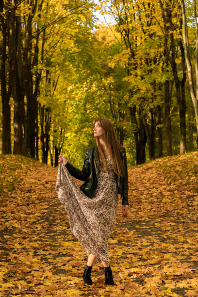 istock A girl is walking in an autumn park 868172452