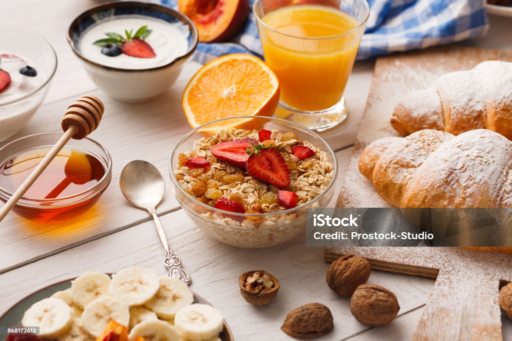 Continental breakfast menu on woden table Rich continental breakfast menu. Delicious natural food for tasty morning meals on wooden table, traditional european buffet Continental Breakfast Stock Photo