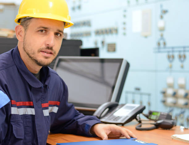 istock Young engineer in working electrical room in power substation 868173198