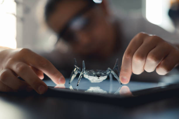 I built my own spider robot Young girl building her own spider robot. robotic arm lab stock pictures, royalty-free photos & images