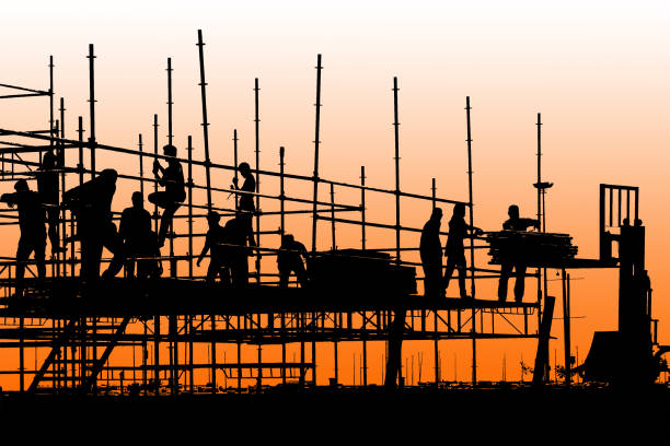 istock Silhouette of construction workers working on scaffolding with twilight sky 868181552
