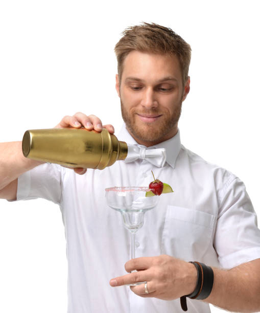 istock Bartender men is preparing red margarita cocktail with strawberry and lime 868184348