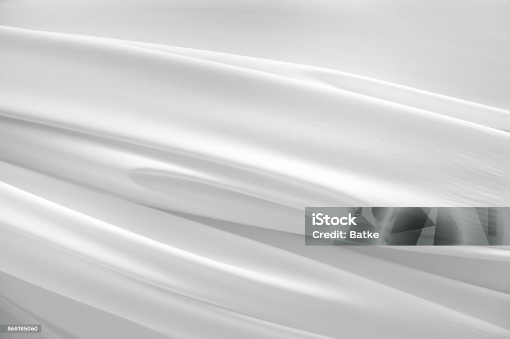 White wavy fabric texture White wavy fabric texture. White luxurious silk pattern brightly lit. Horizontal image Curtain Stock Photo