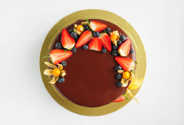 istock Cake in chocolate glaze with strawberries, blueberries and physalis. 868187754