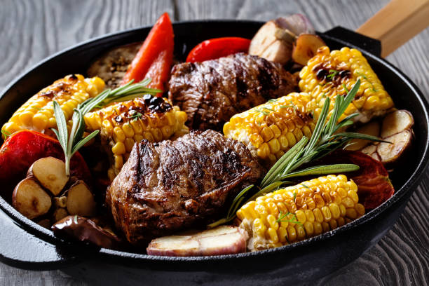 istock Fried meat and vegetables with rosemary in a frying pan 868189370