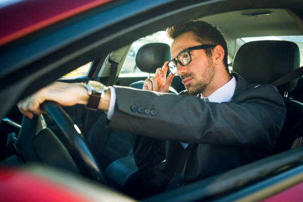 istock handsome businessman driving car 868191686