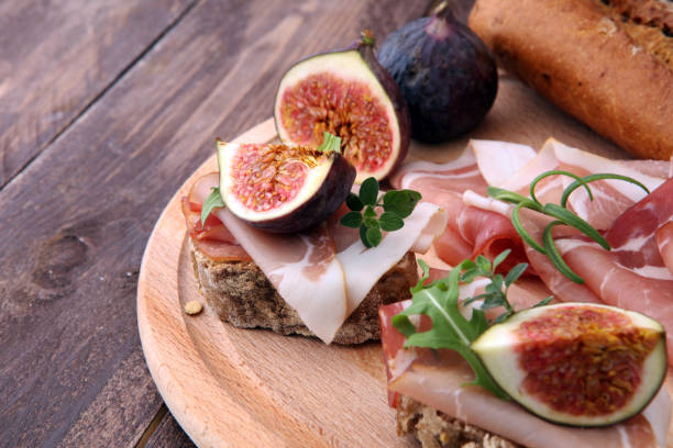 istock Sandwich with figs and prosciutto. Antipasti gourmet bruschetta snack 868192040